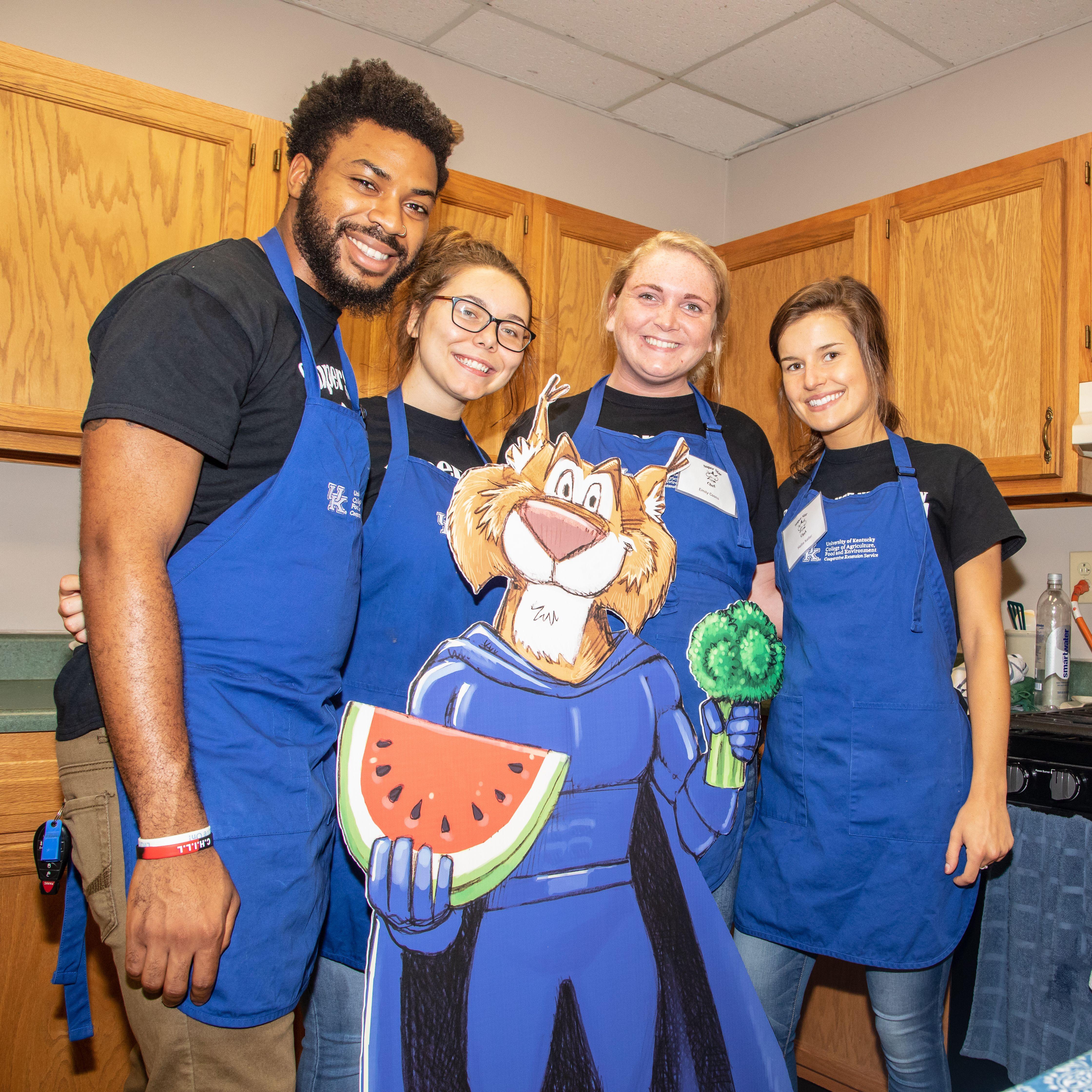 Students in UK blue aprons 